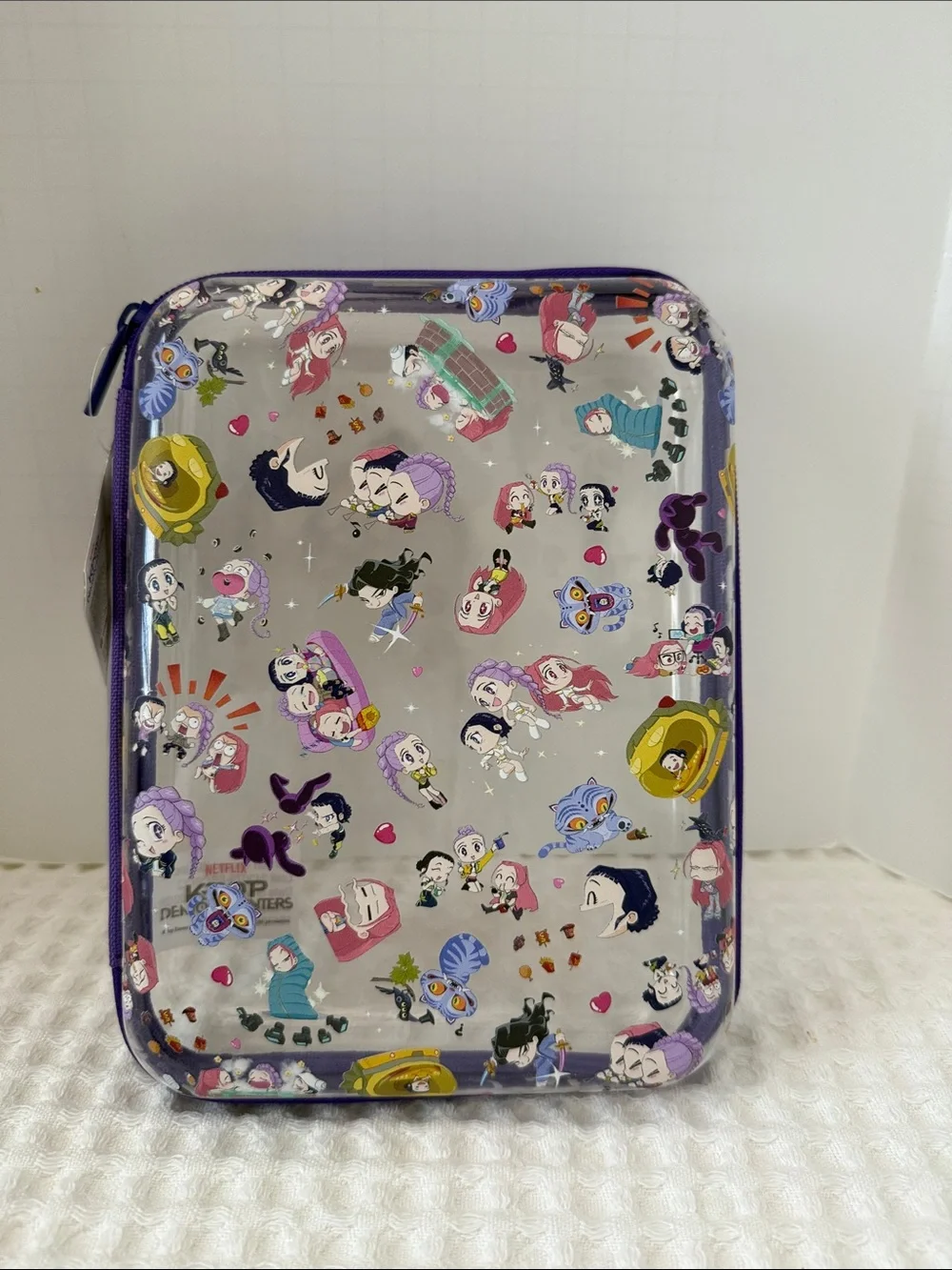 Netflix K-POP Demon Hunters Chibi-Style Clear PVC Pencil Case with Purple Trim.